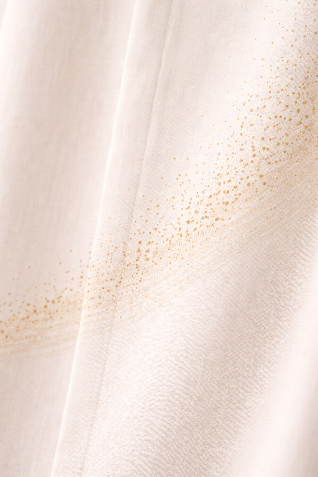 The Shoulder Dust Shirt detail — Bandhani dot pattern on rust organic cotton
