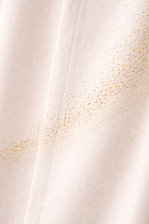 The Shoulder Dust Shirt detail — Bandhani dot pattern on rust organic cotton